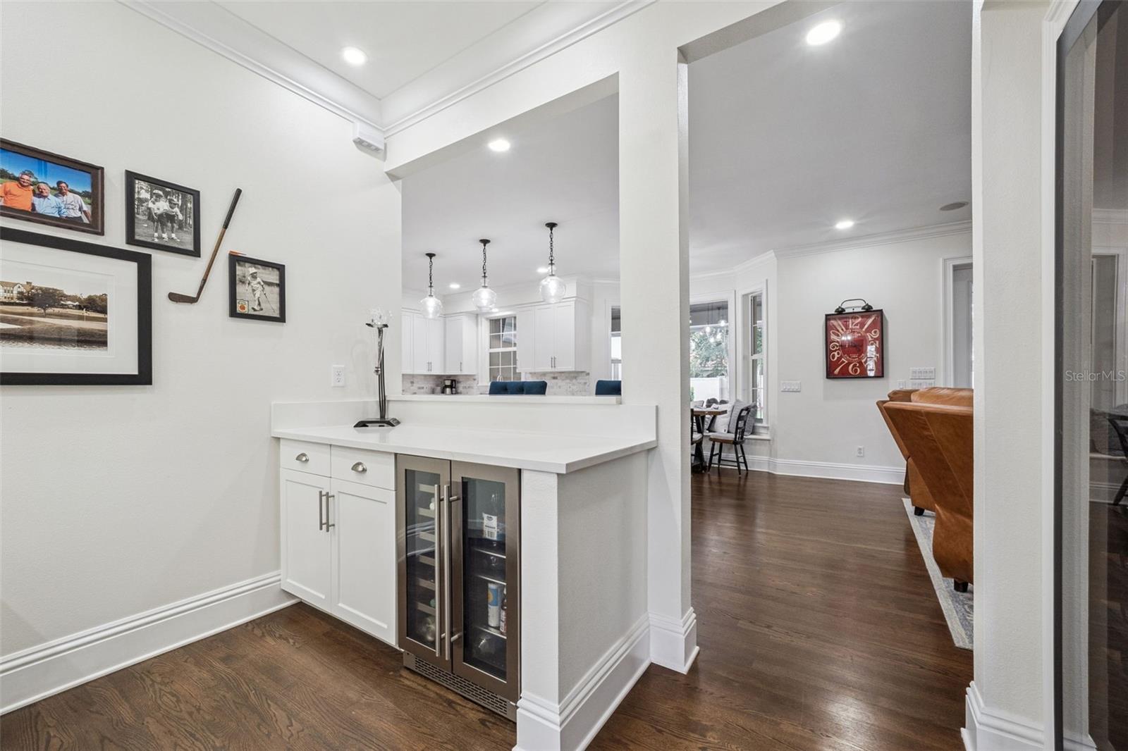 Bar Service area with beverage cooler, ice maker, sink, storage and plenty of counter top space