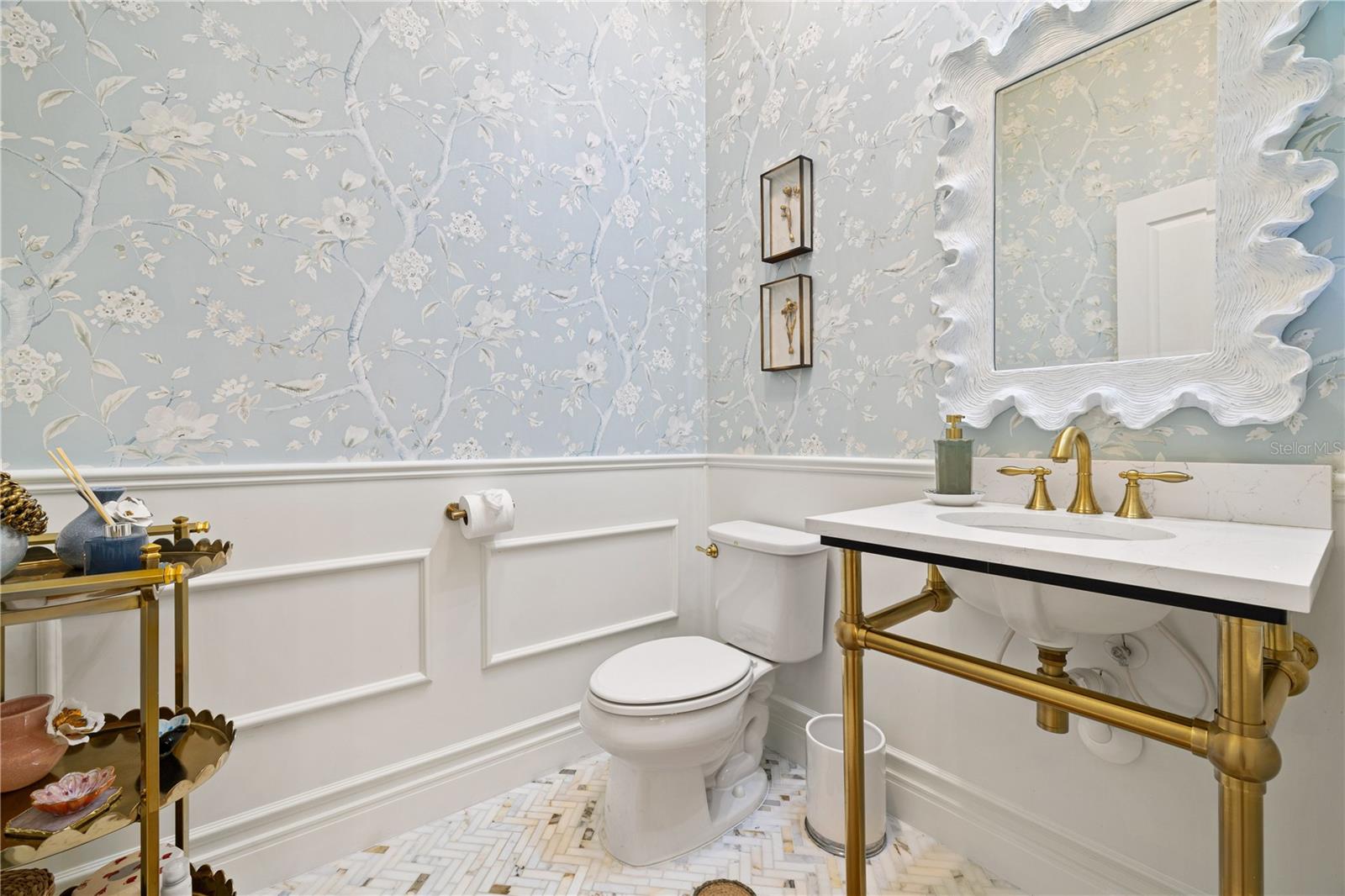 1/2 bathroom with boiserie and wall paper.