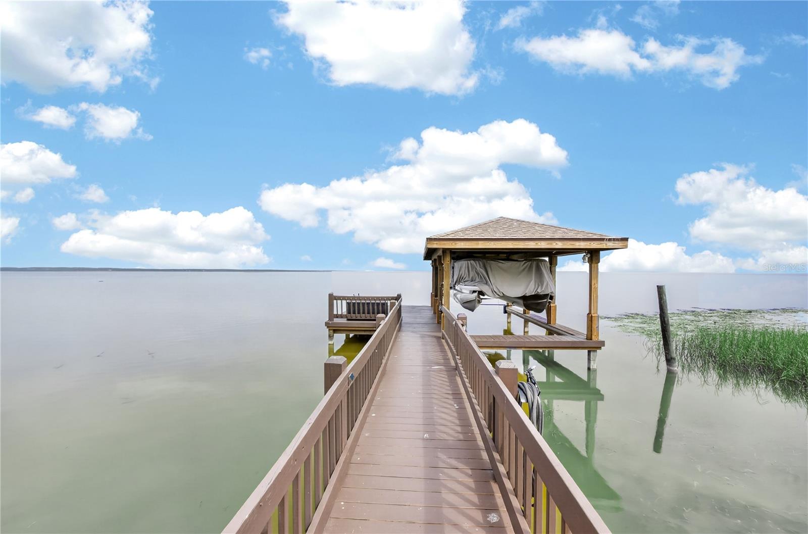 Boat dock with covered boat lift. New roof on the boat lift 2025