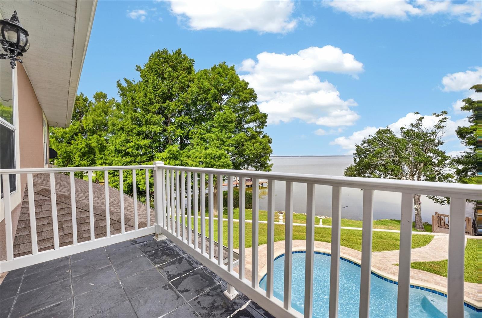 Balcony off the primary bedroom with lovely lake views