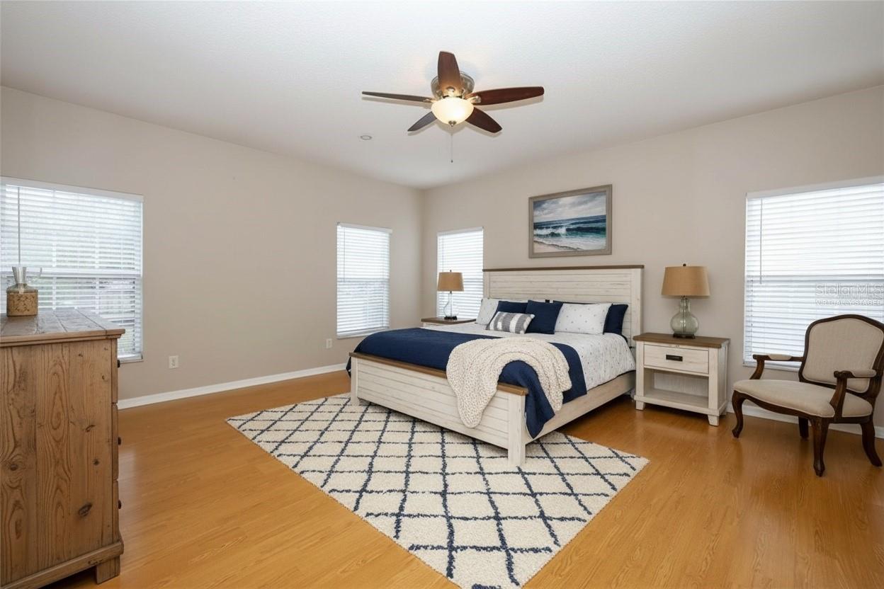 Spacious Apopka Primary Bedroom provides room for a king-size bedroom set, sitting area, and additional furnishings while maintaining a comfortable retreat-like feel.