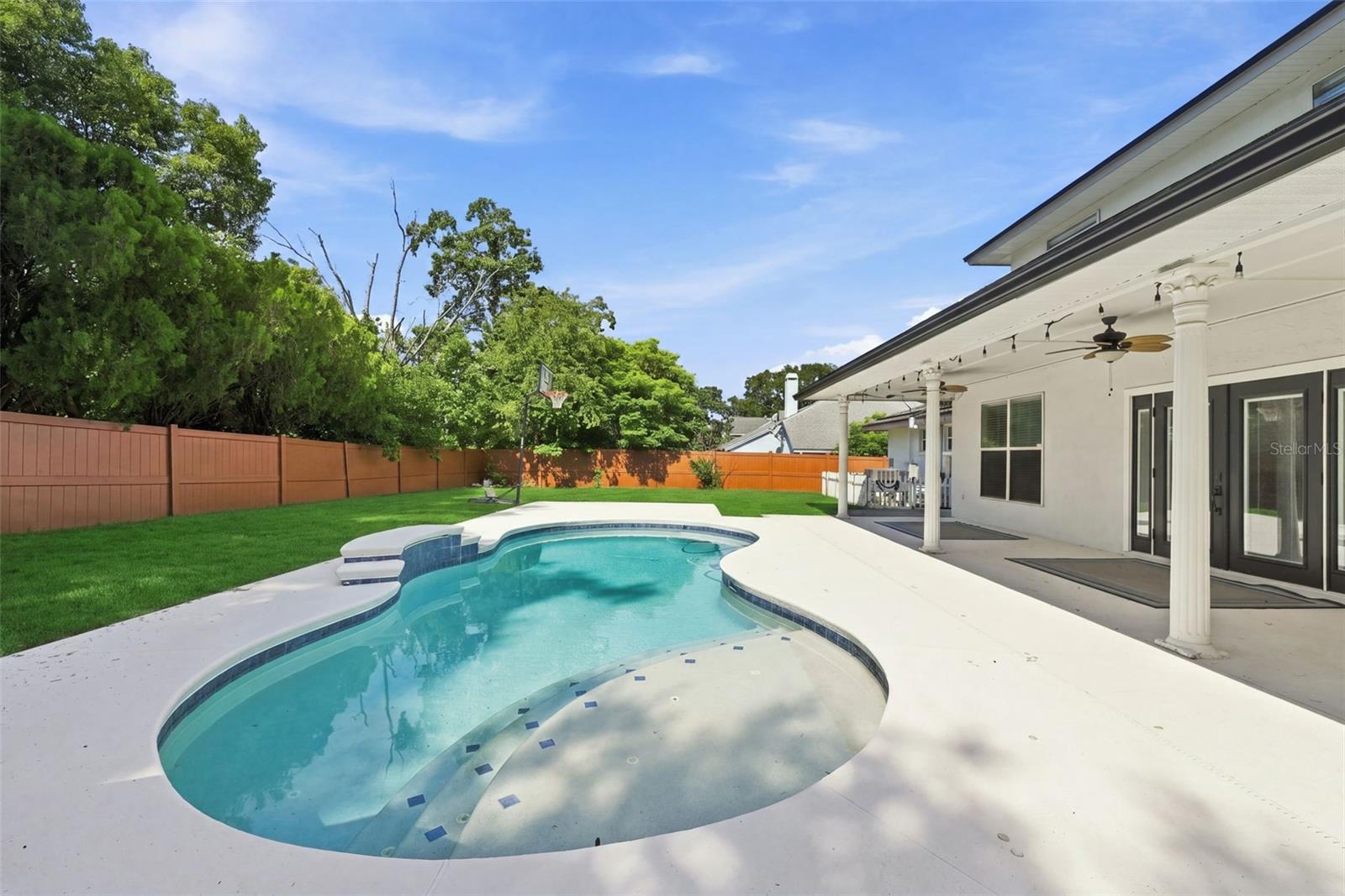 Private Saltwater Pool & Outdoor Living! Enjoy Florida living with a solar-heated saltwater pool, expansive pool deck, and covered outdoor entertaining area.