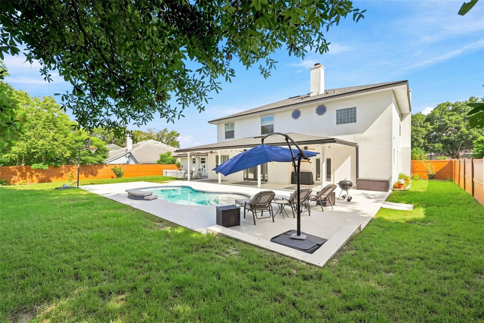 Oversized backyard with basketball pad