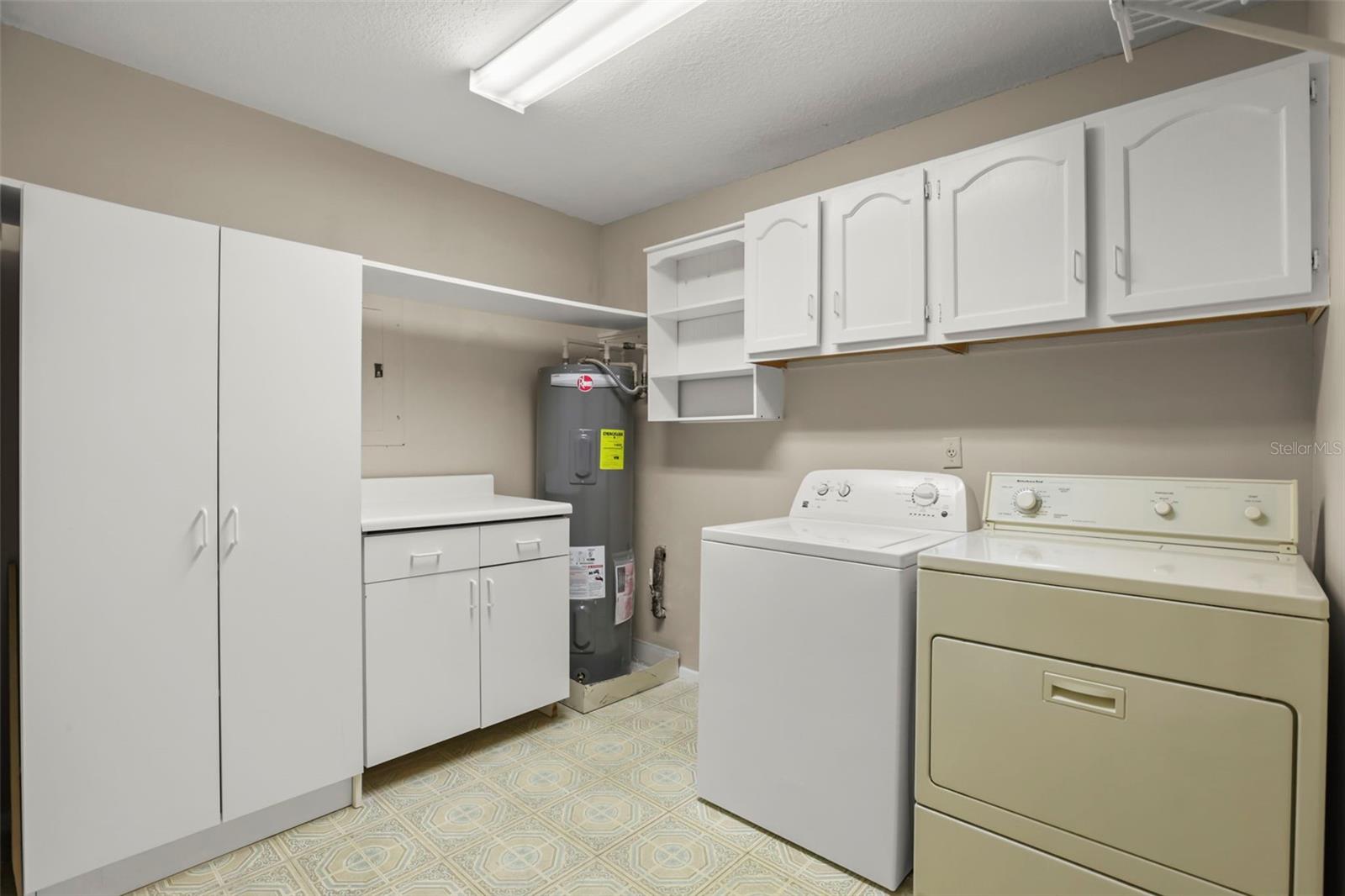 This condo boasts an IN UNIT laundry room with phenomenal storage above the washer and dryer and additional cabinets and counter space adjacent.