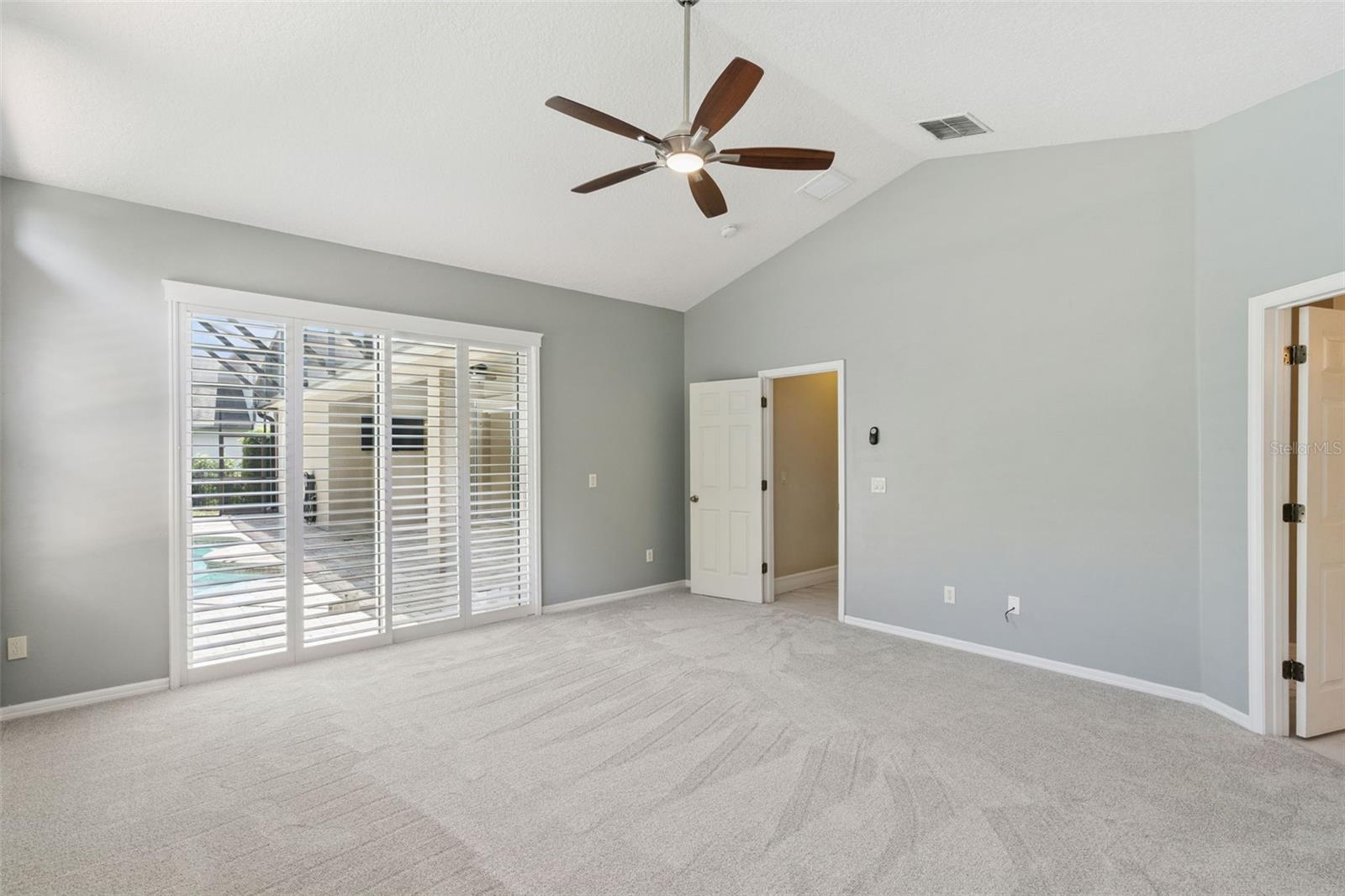 PRIMARY BEDROOM WITH POOL VIEW