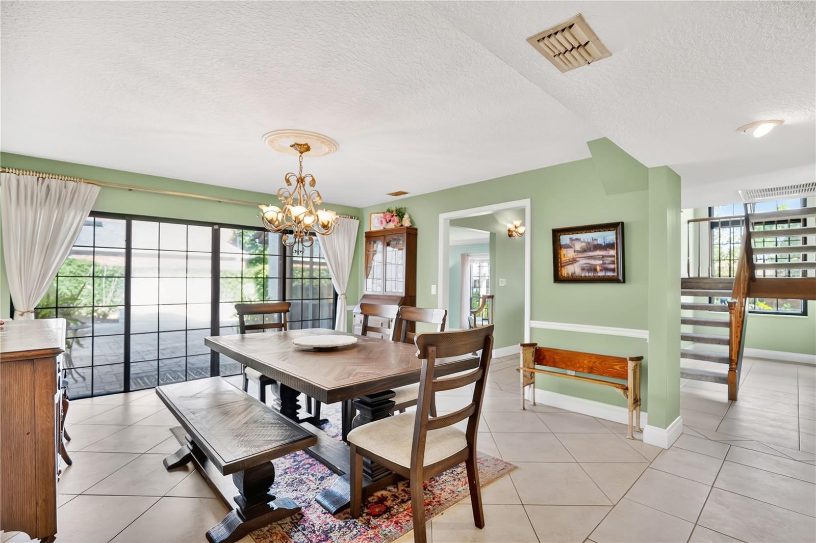 The formal dining room leads to an outdoor courtyard and fountain. The formal dining room leads to an outdoor courtyard and fountain.