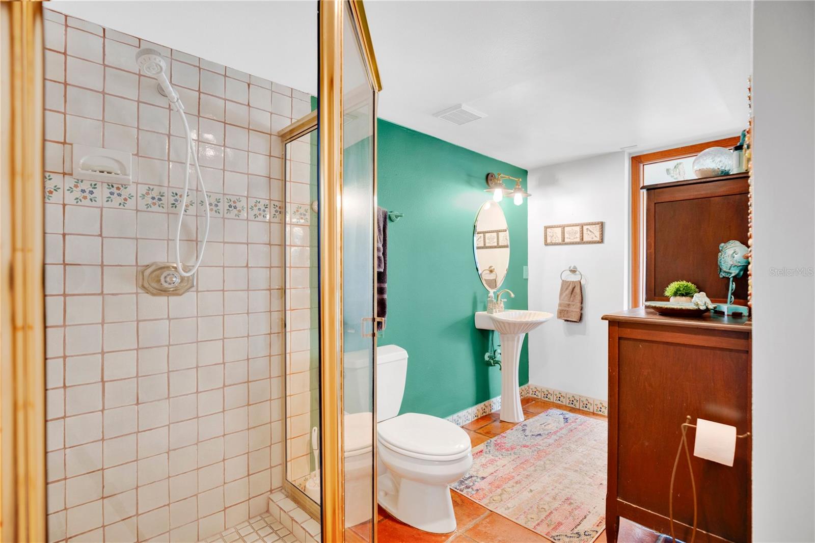 The full bath next to the office offers access to the kitchen as well as the outside.