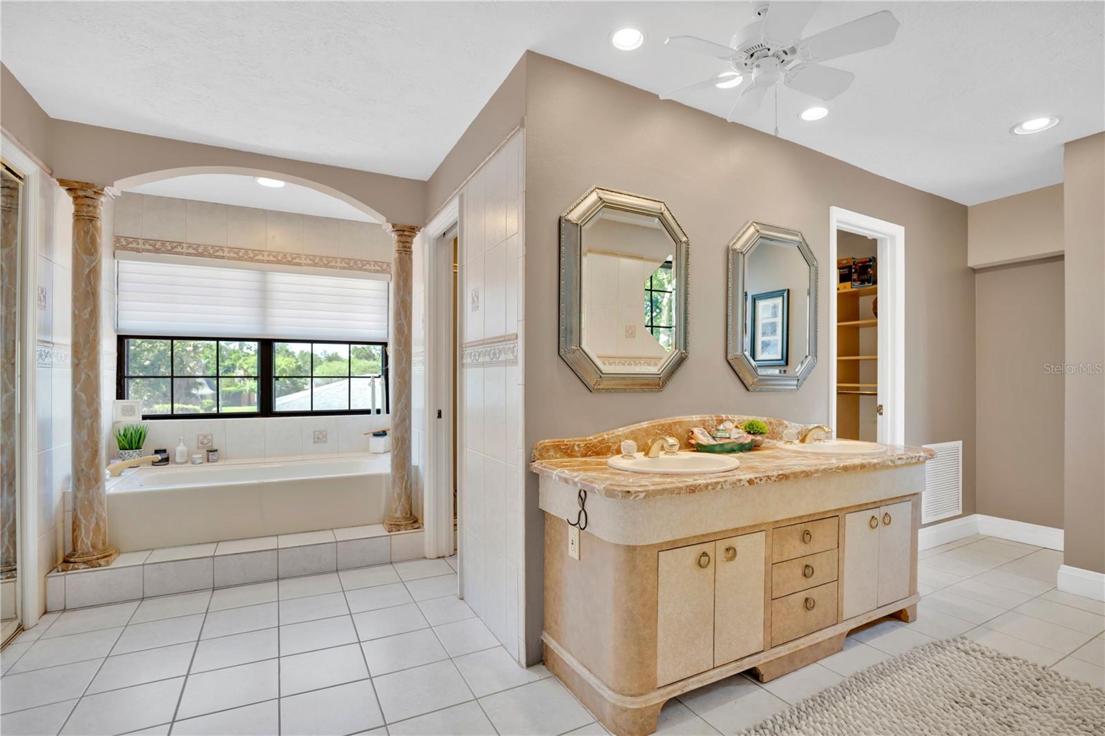 The primary bathroom offers dual walk-in closets, a soaking tub, and a separate shower.