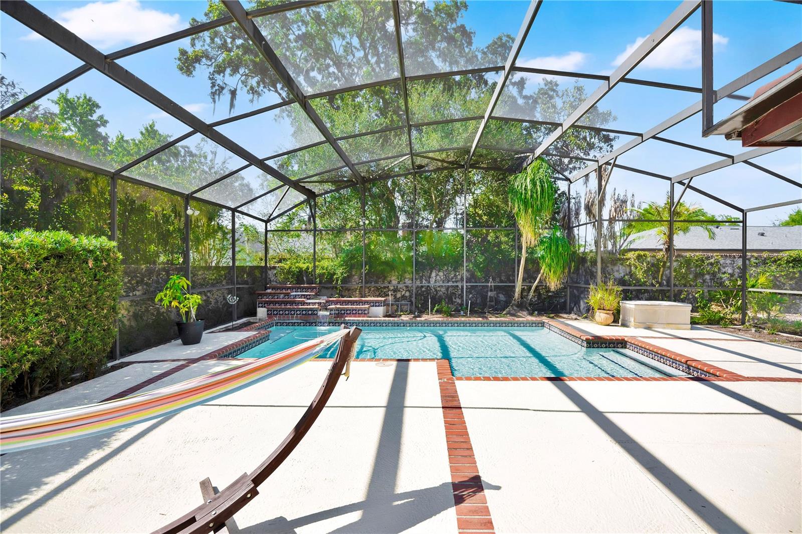 The screen-enclosed pool invites you to enjoy the Florida summer