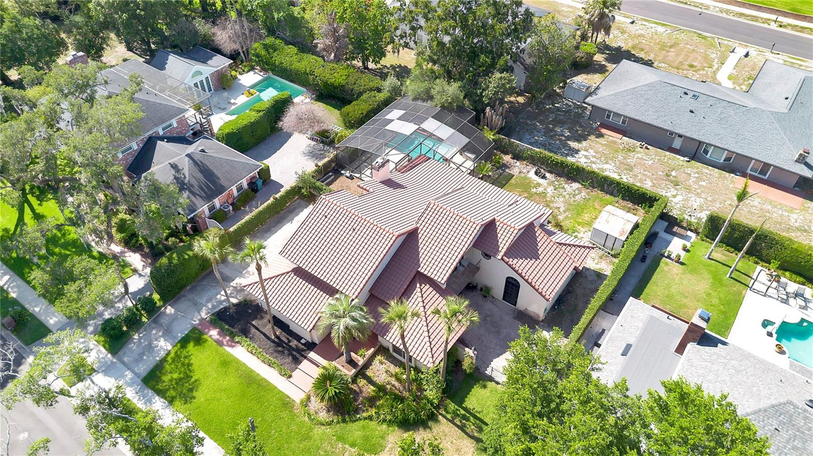 The backyard is fully enclosed by a block wall and secured with wrought iron gates.