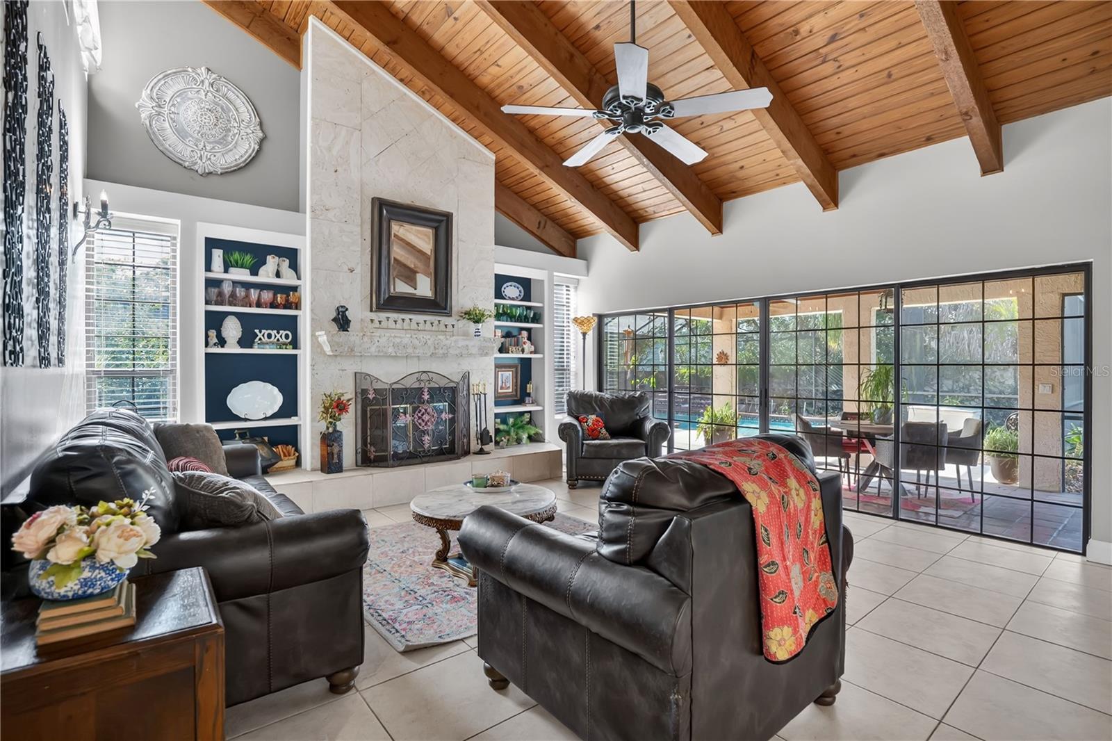 The great room with exposed wood beams and wood-burning fireplace The great room with exposed wood beams and wood-burning fireplace