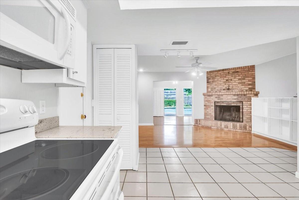 Kitchen to living area with beautiful brick fireplace.