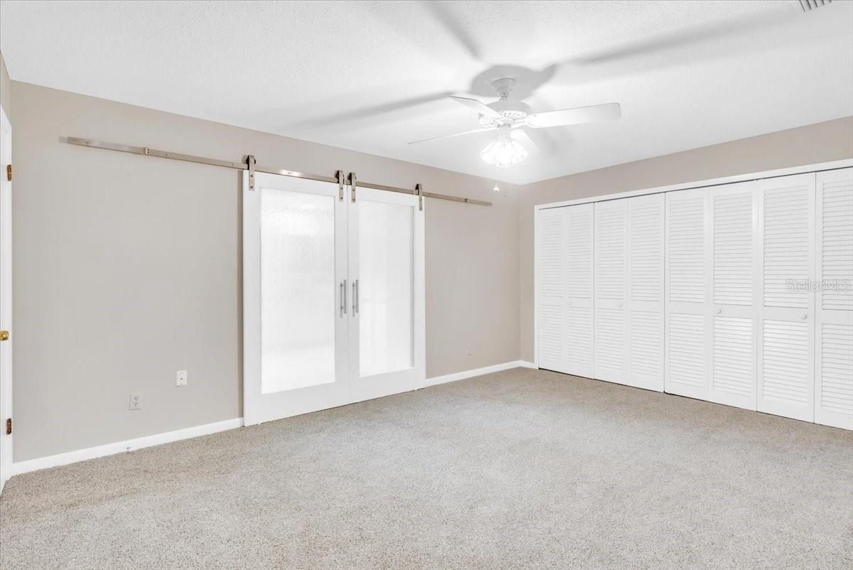 New barn style doors in primary bedroom suite.