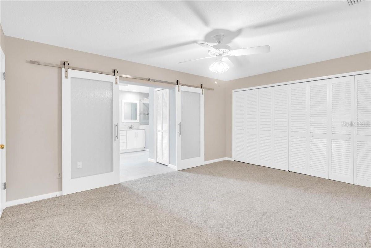 Primary bedroom suite with new carpeting and paint.