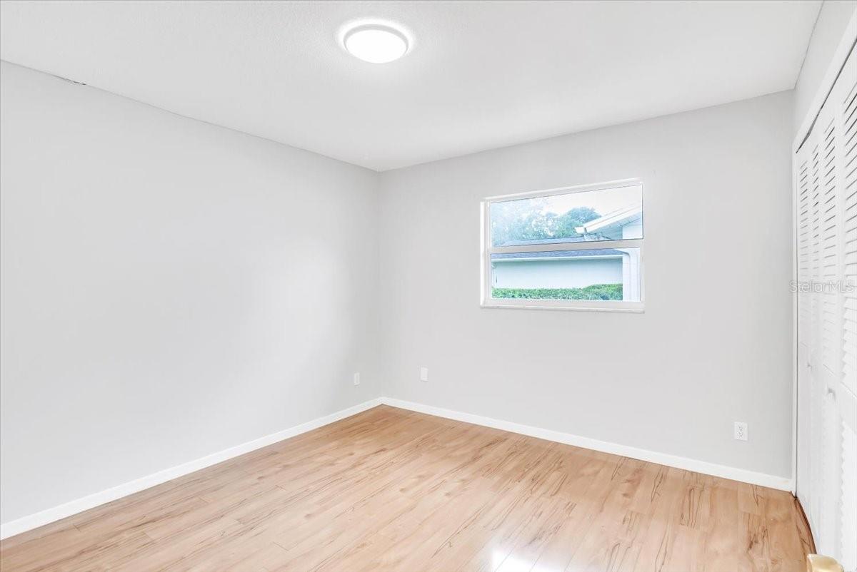 Bedroom #2 with hardwood flooring.