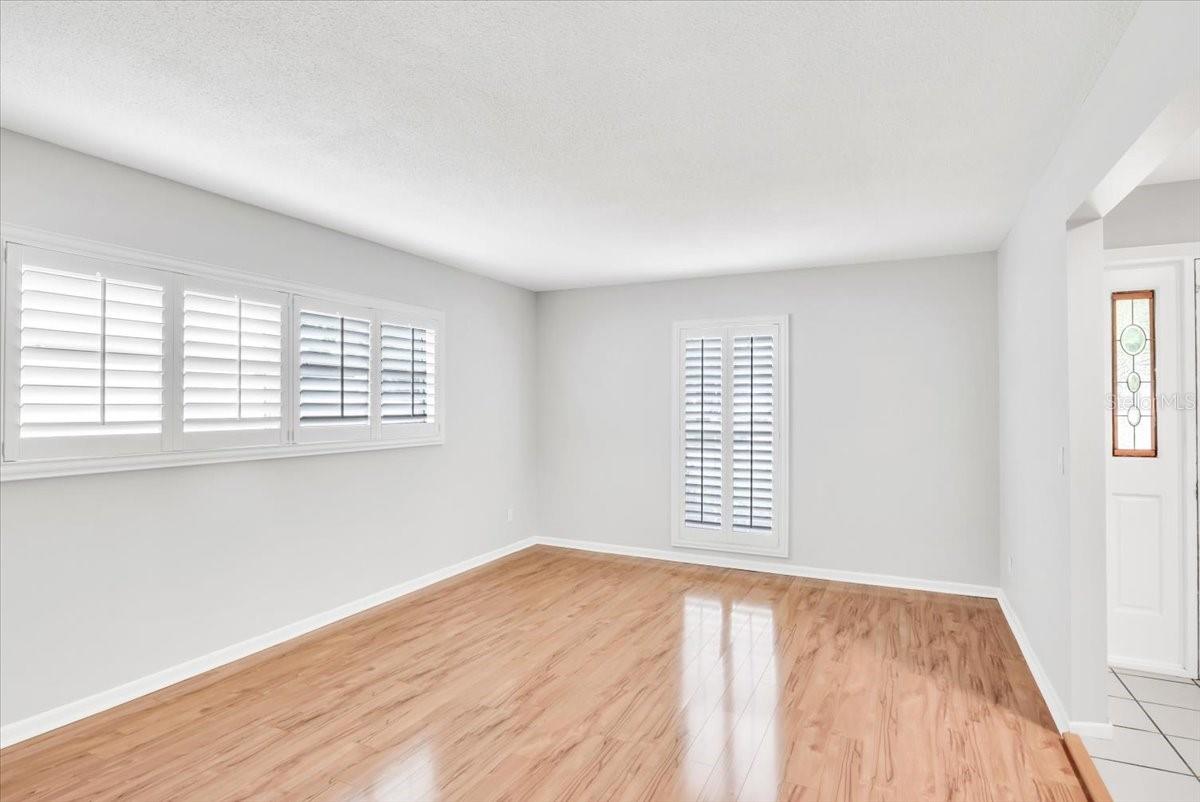 Living area #2 with upgraded hardwood floors and plantation style shutters.