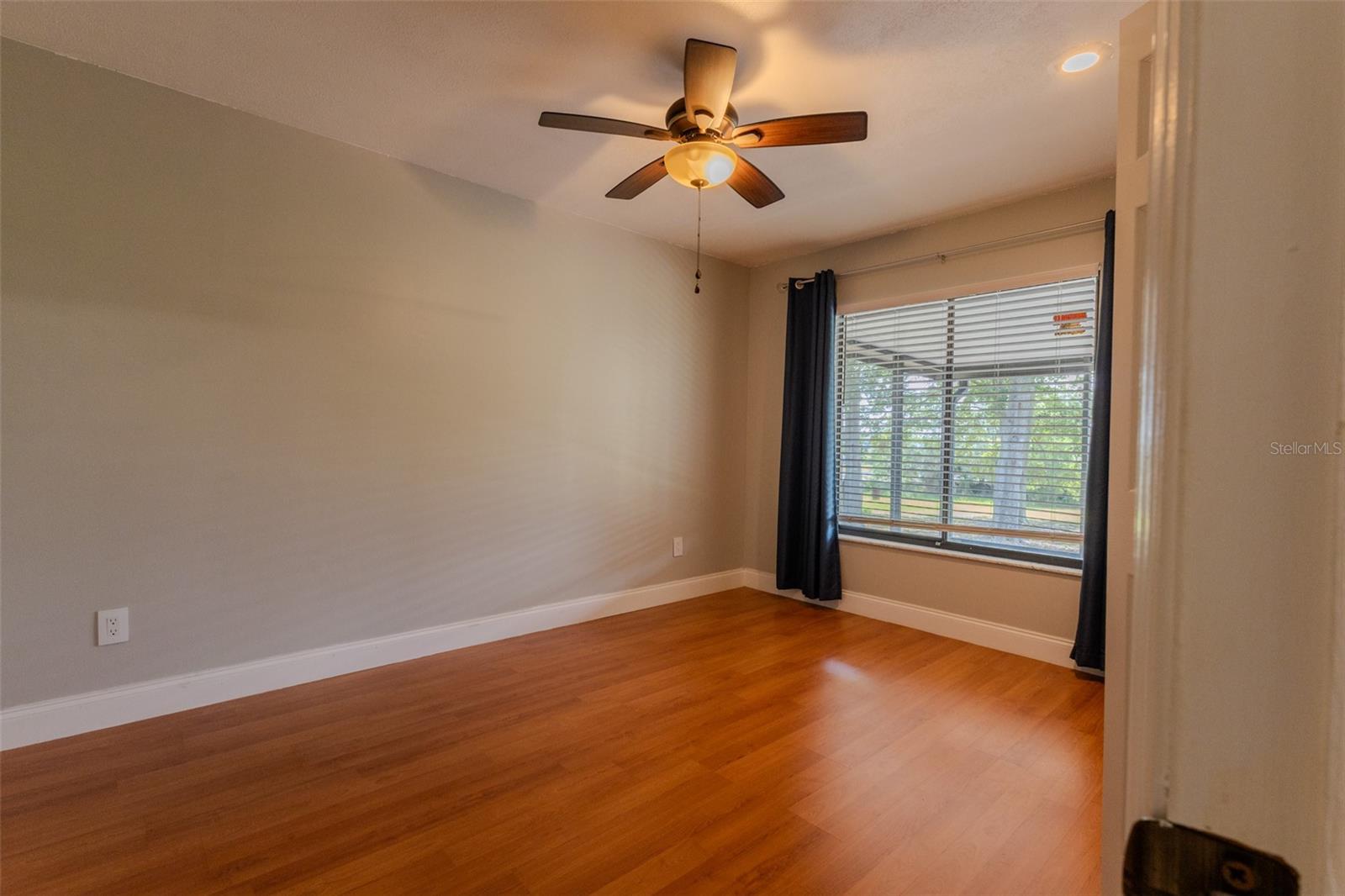 Split-side guest bedroom 2 with window facing lanai