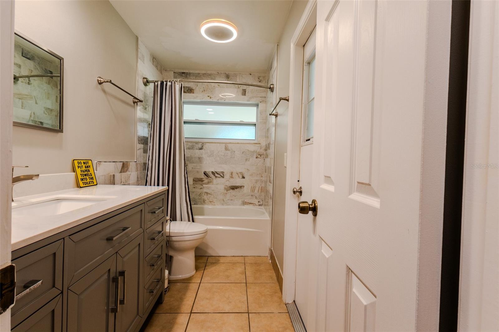 Guest bath with access door to porch/lanai