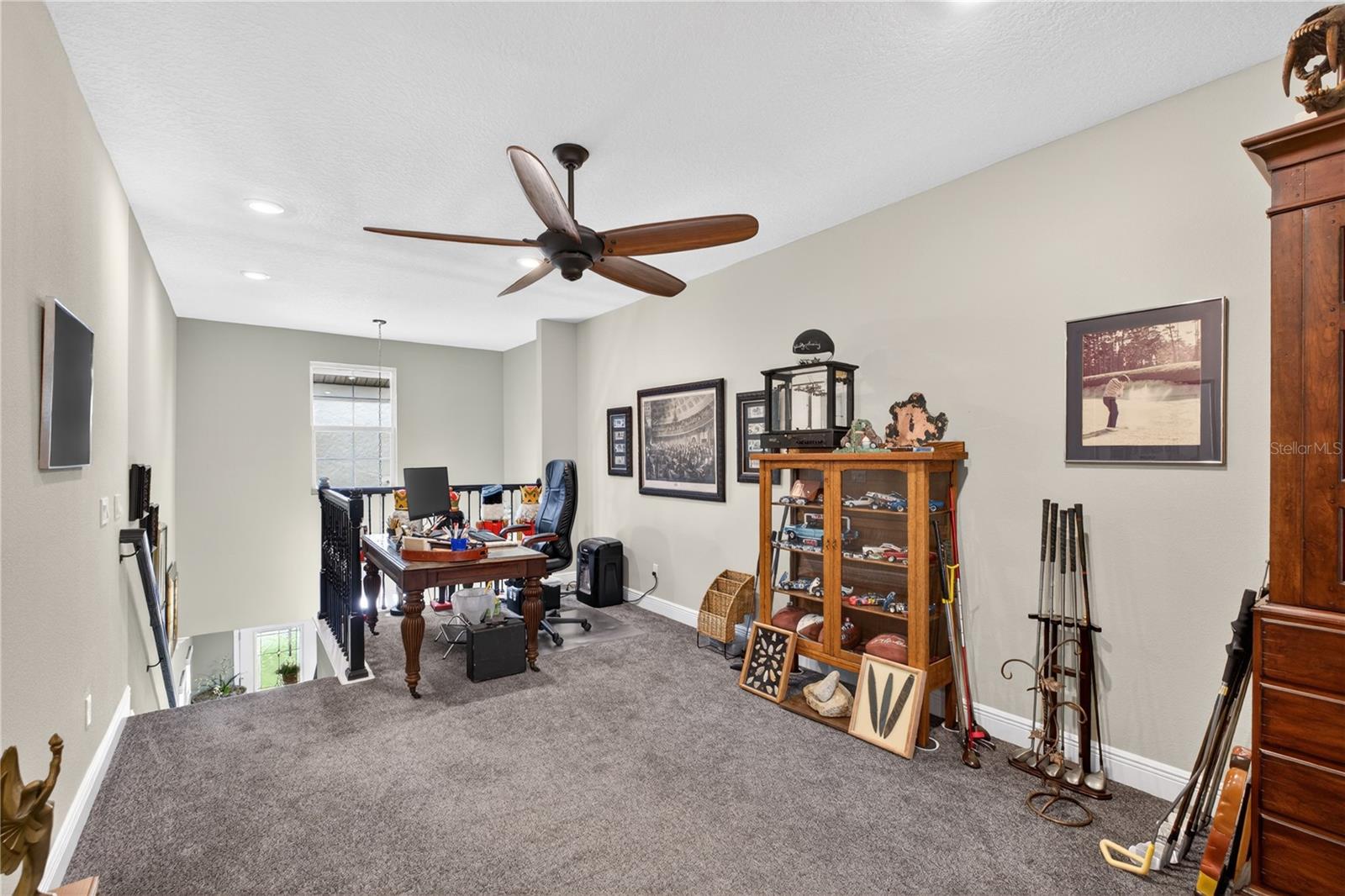 This photo features the staircase leading to the upper level, which is fully carpeted and includes a designated entertaining area.