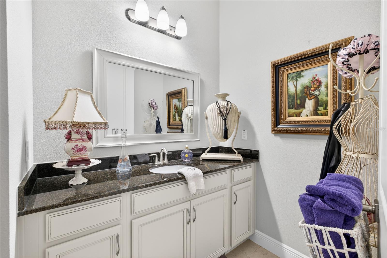 Vanity featuring mirror on the wall on upper level.