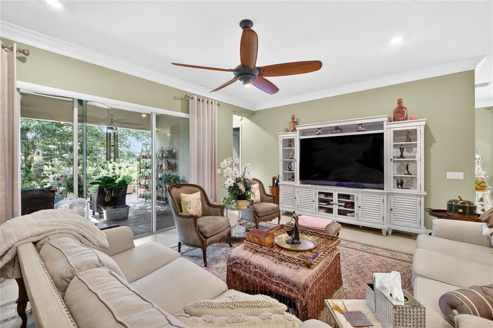 View of the backyard and porch from the family room through the sliding glass doors.