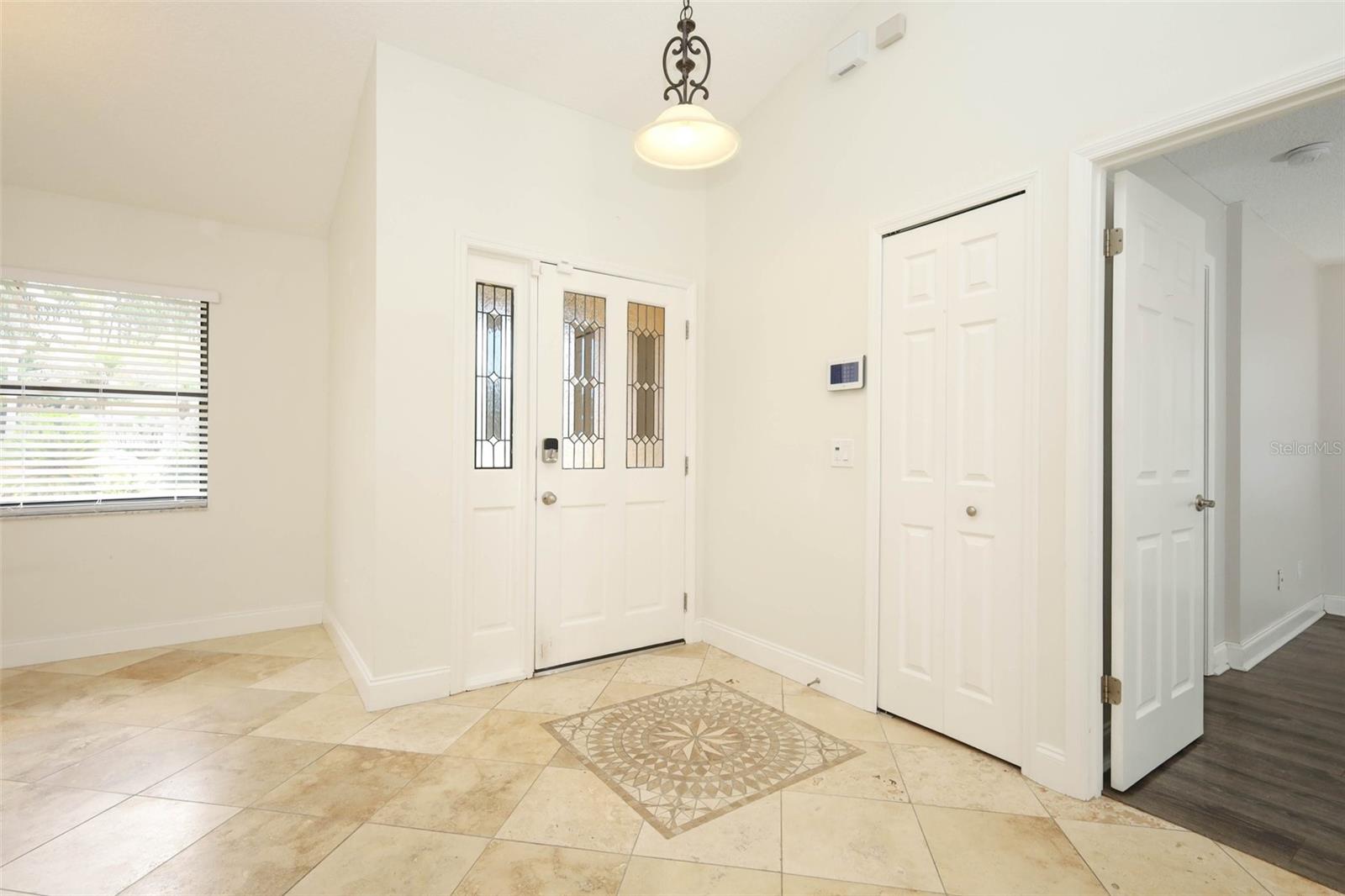 Foyer with Travertine tile flooring.