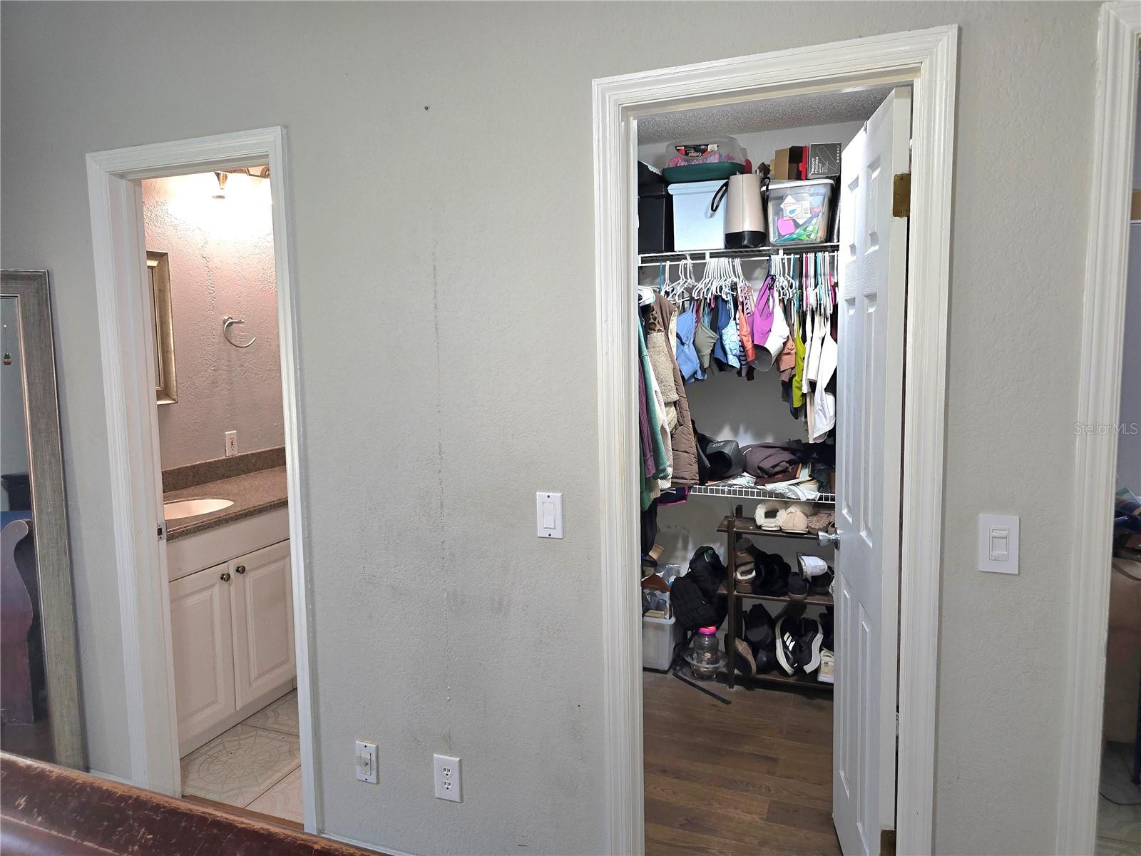 Primary bedroom walk in closet