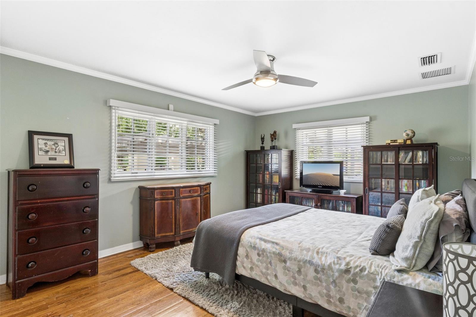 Bedroom #3 featuring customed closet and natural wood floors.