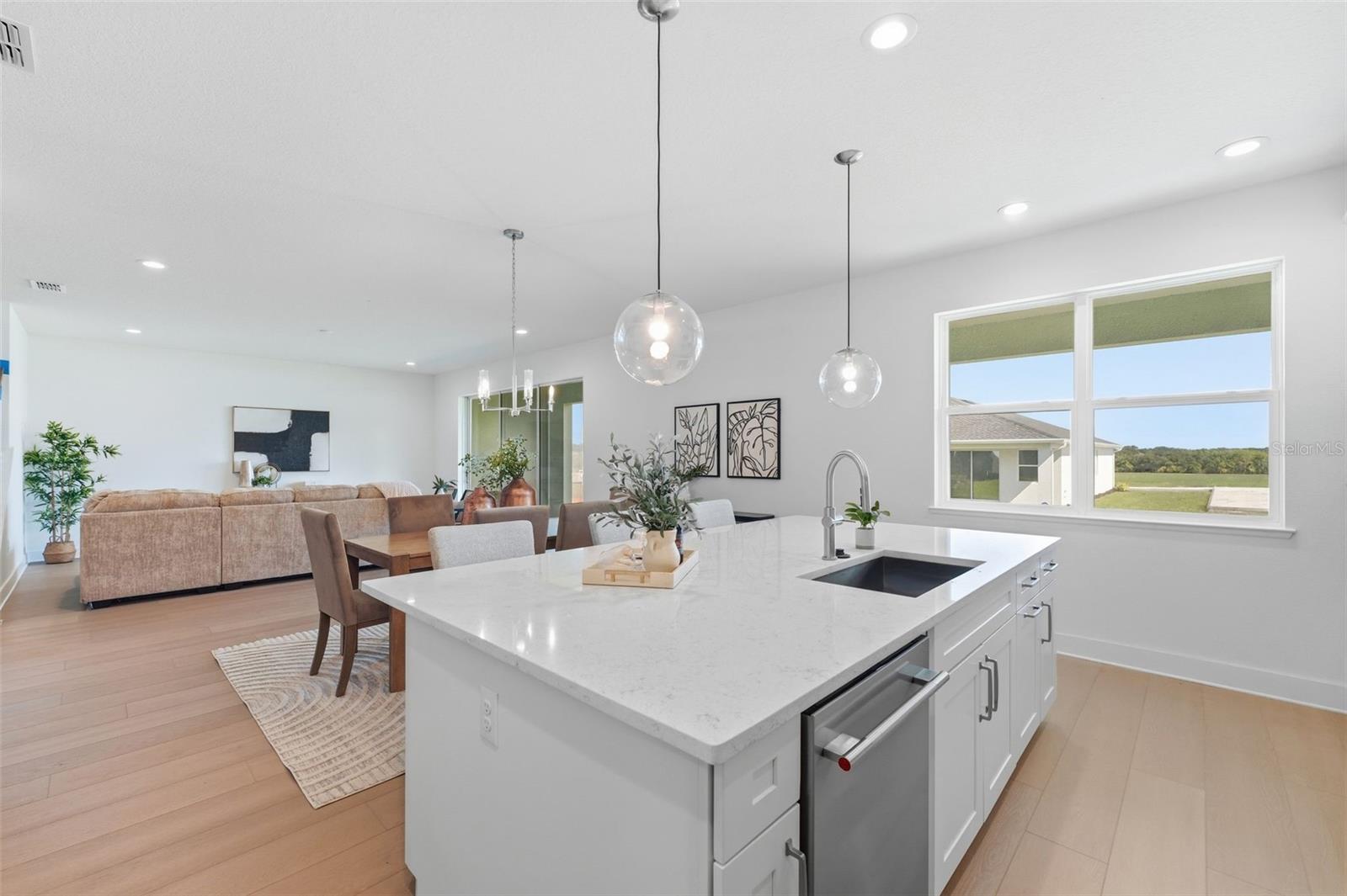 Kitchen overlooking dining room and great room