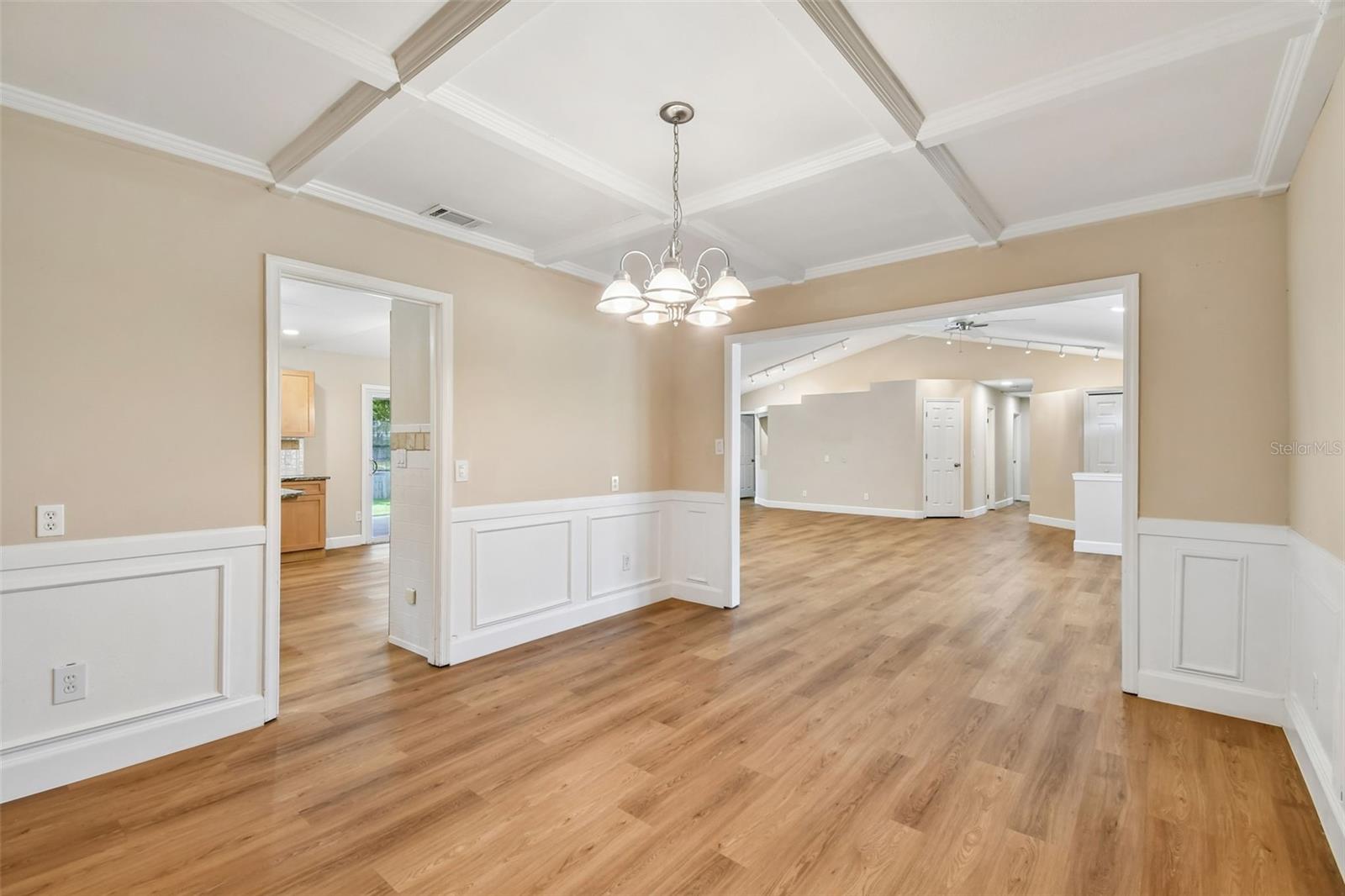 Stunning Dining Room with embolished ceiling and wainscotting