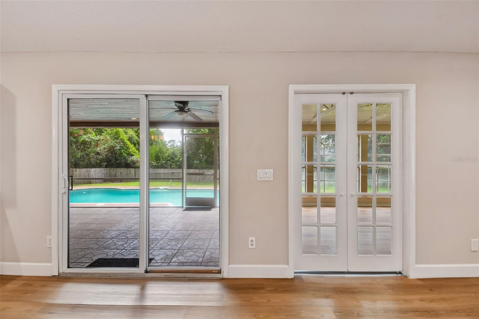 Great Room overlooking enclosed Bonus Room, Enclosed Porch, and Pool.