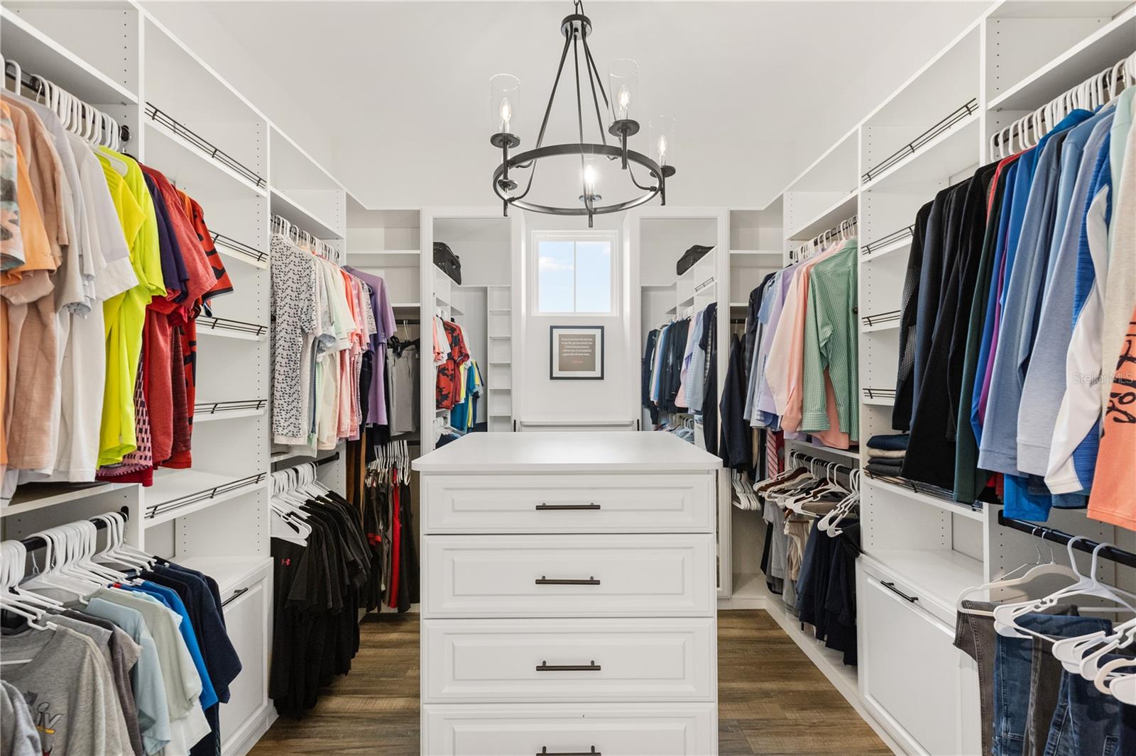OVERSIZED WALK-IN CLOSETThe primary suite includes an oversized walk-in closet with extensive built-in storage, a center island with drawers and abundant hanging space.
