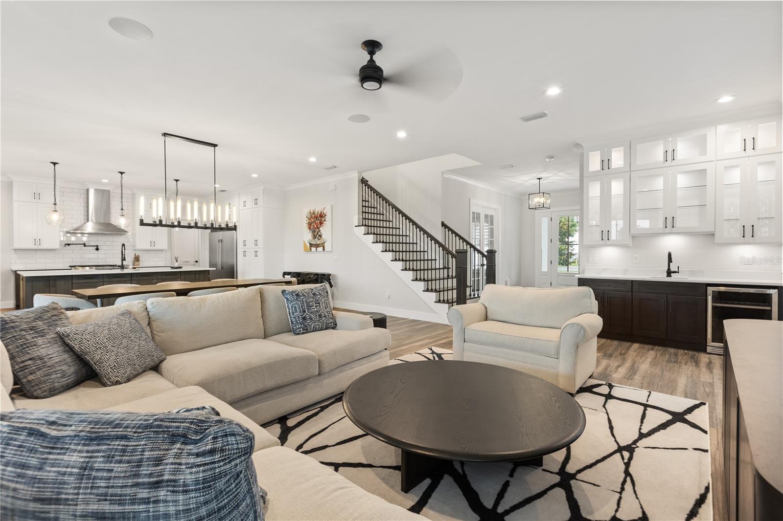 OPEN-CONCEPT The main living area connects the kitchen, dining space and built-in wet bar in an open-concept layout designed for everyday living and entertaining.