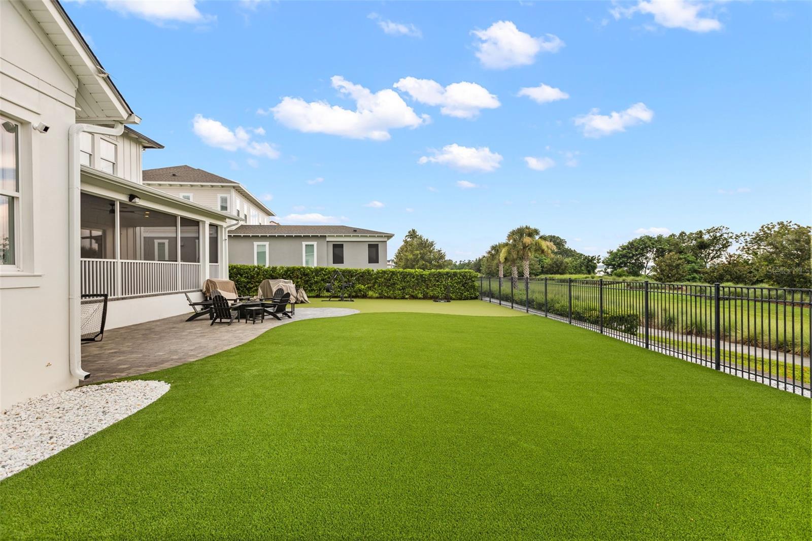EXPANSIVE FENCED BACKYARDA broad fenced backyard finished with low-maintenance turf provides substantial space for recreation, entertaining and future outdoor improvements, with conservation land beyond.