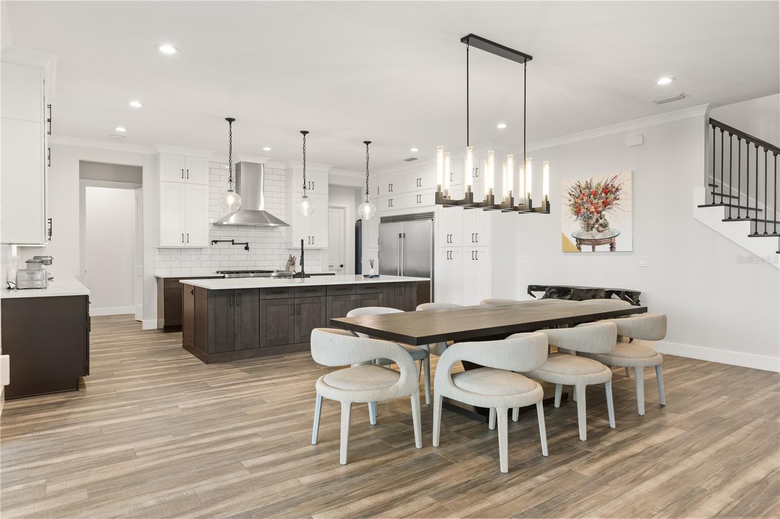 EXPANSIVE KITCHEN + DININGAn oversized center island anchors the gourmet kitchen, with abundant cabinetry and an open dining area designed to accommodate a large table and effortless entertaining.