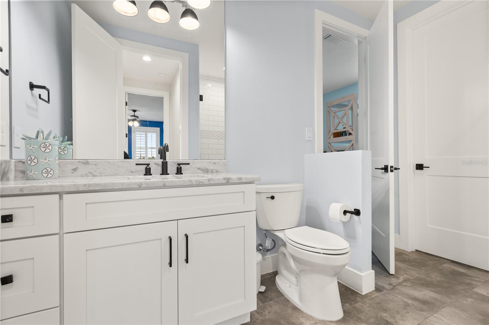 EN SUITE FULL BATHA private full bath serves the adjoining second-floor bedroom, with a separate hallway entrance providing additional access from the loft level.