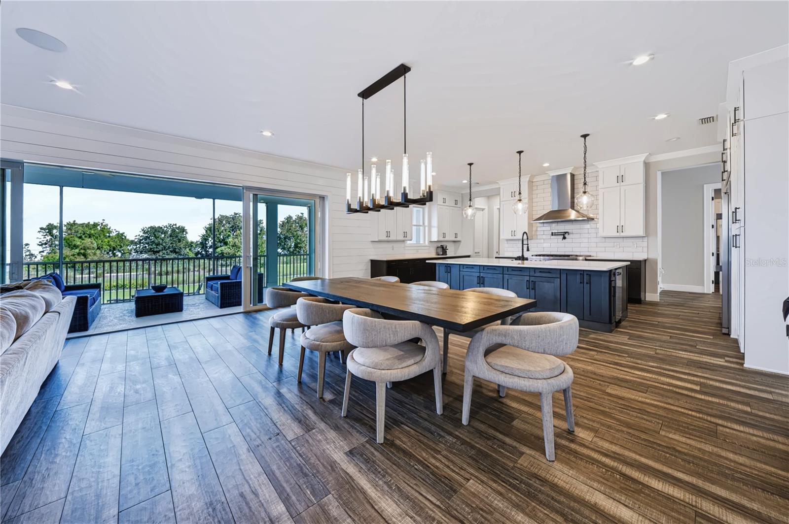 GOURMET KITCHENA spacious gourmet kitchen with a large center island and generous seating opens directly to the living and dining areas, with expansive sliders beyond.sliding doors opening to an expansive porch over conservation and Lake Apopka.