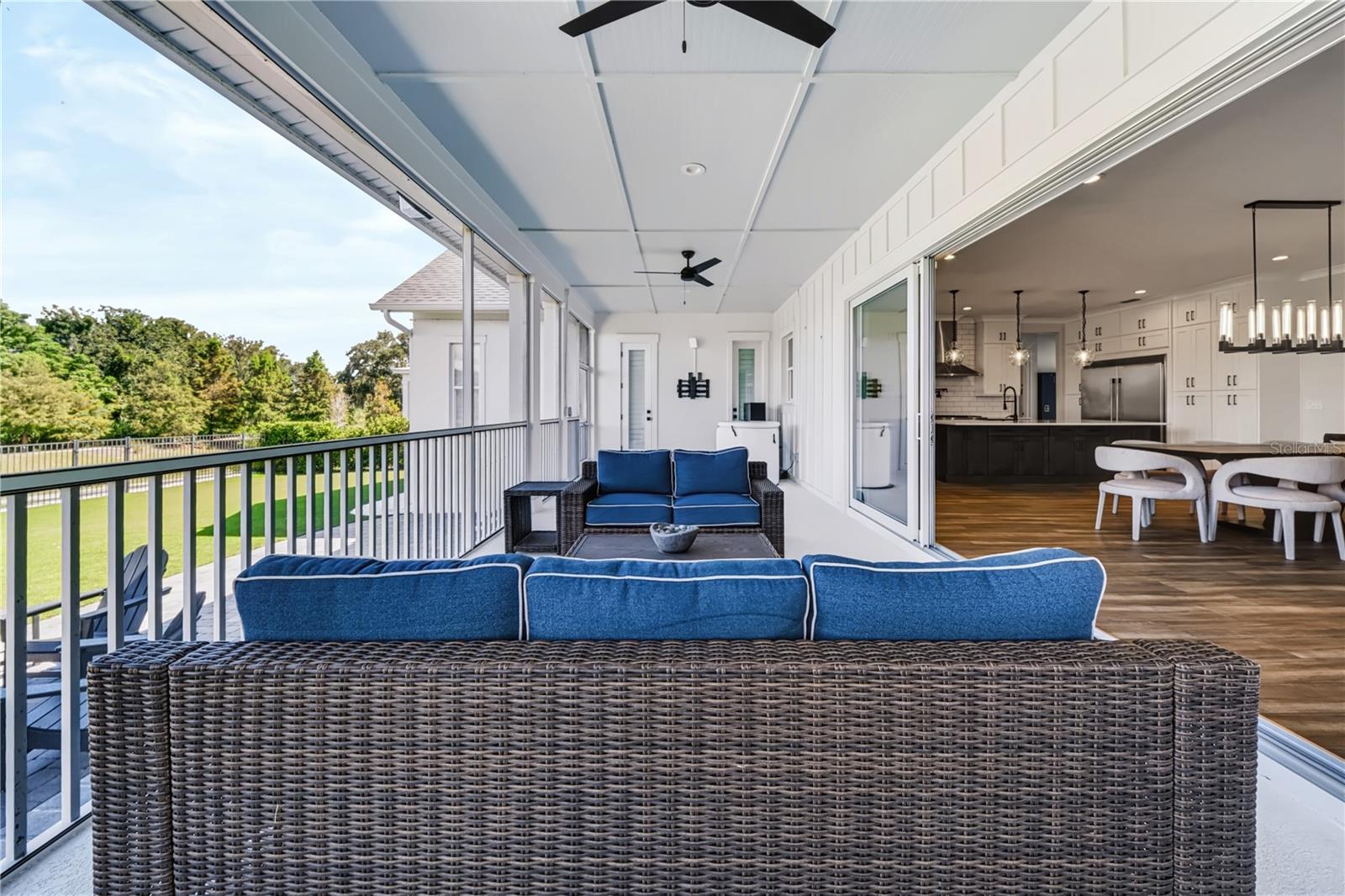 CONSERVATION VIEWSThe screened porch overlooks the backyard and conservation landscape, while wide sliders provide direct access to the kitchen and dining areas.
