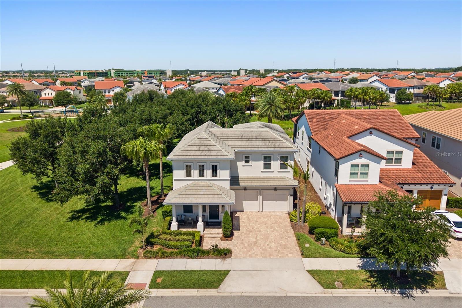 8836 Lakeshore Pointe Dr sits on a site with expansive, open green space to the south side, allowing natural light into the main living areas of the home all day.