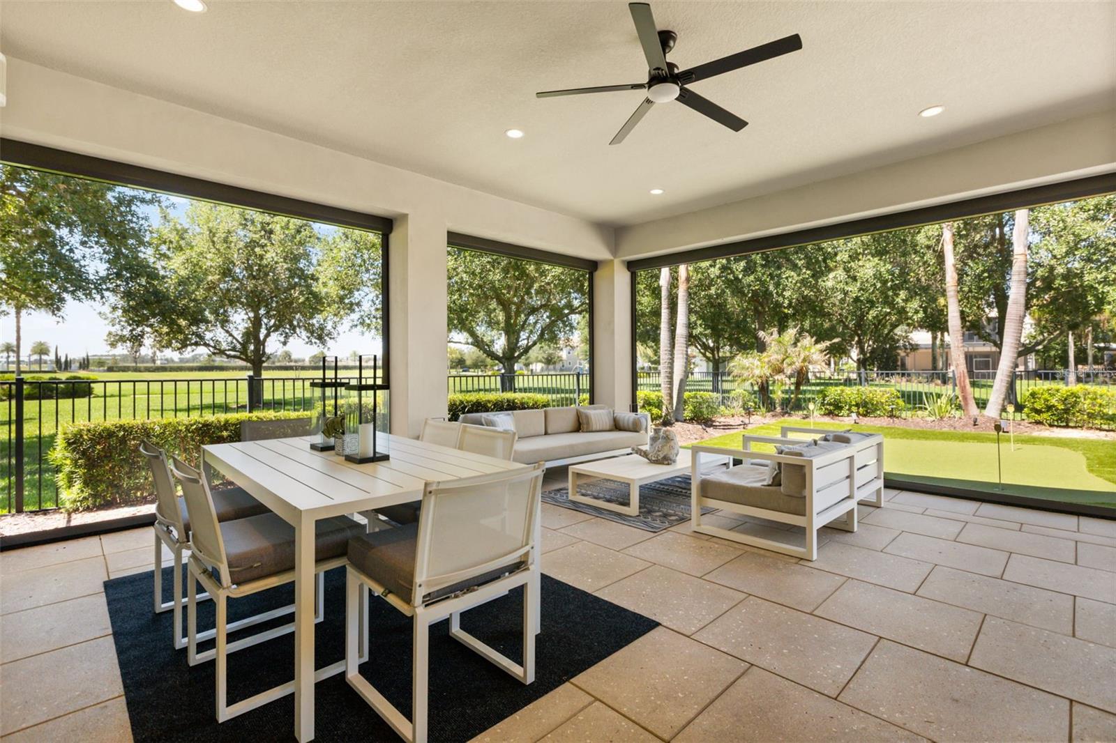 Custom motorized blinds open across all 3 sides of this lanai. A putting green directly facing ahead. Expansive protected green space south side. Custom motorized blinds open across all 3 sides of this lanai. A putting green directly facing ahead. Expansive protected green space south side.