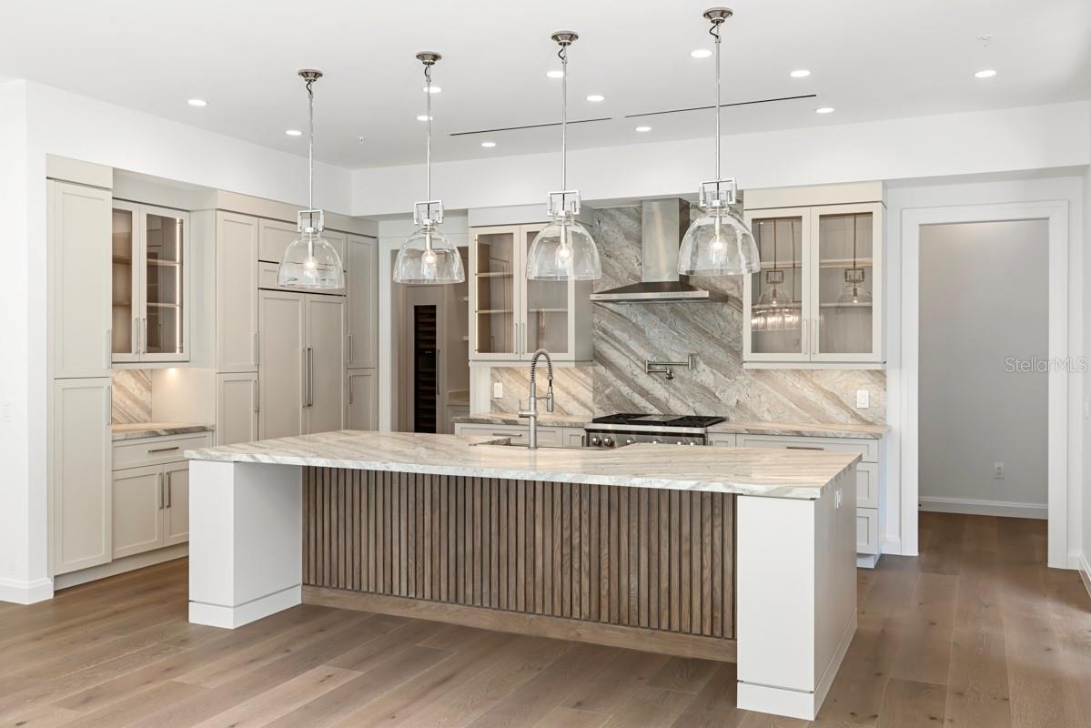 Gourmet kitchen with frameless contemporary cabinetry and alarge prep island
