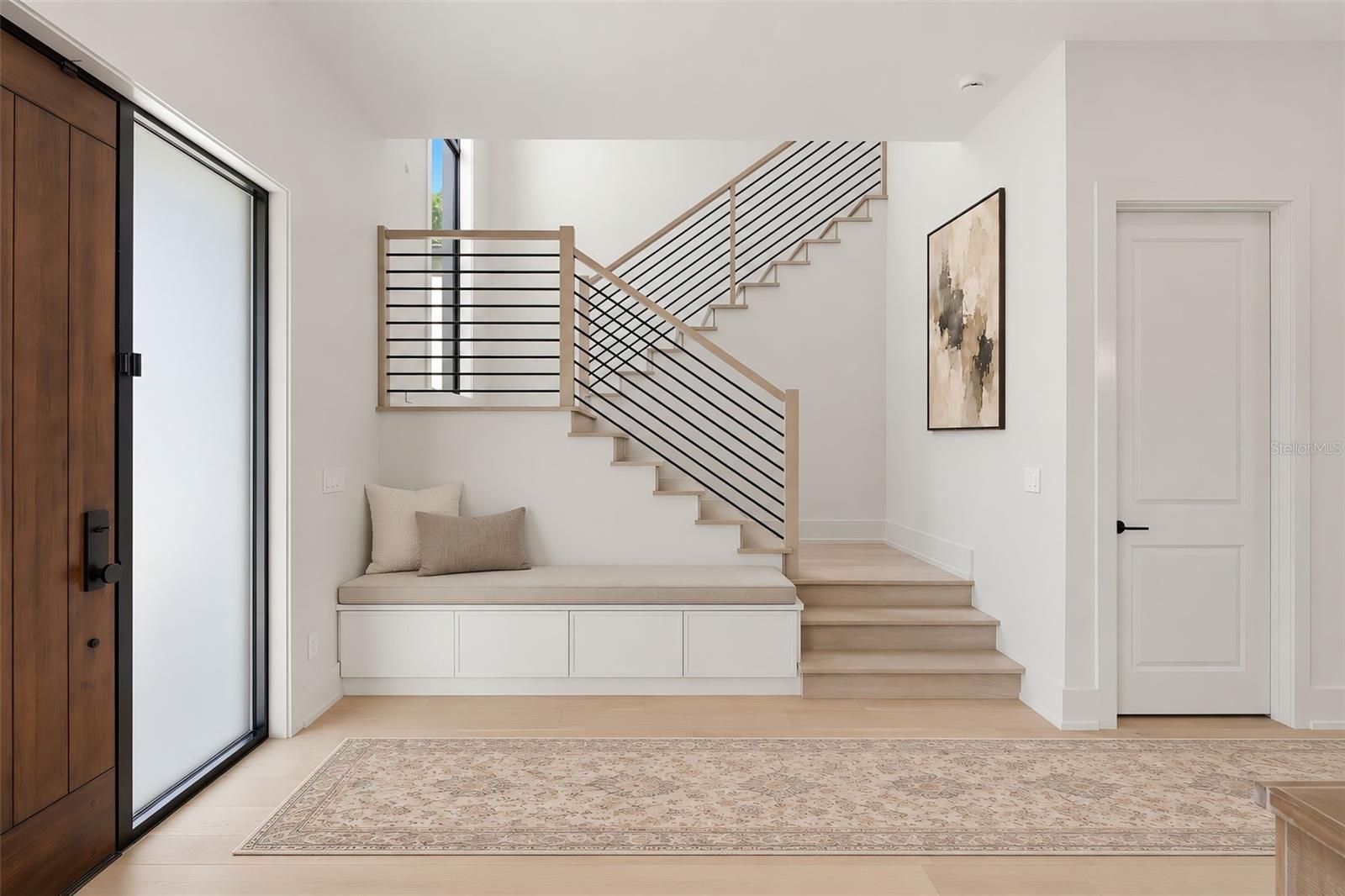 Clean lines of the modern stairway and storage closet to the right