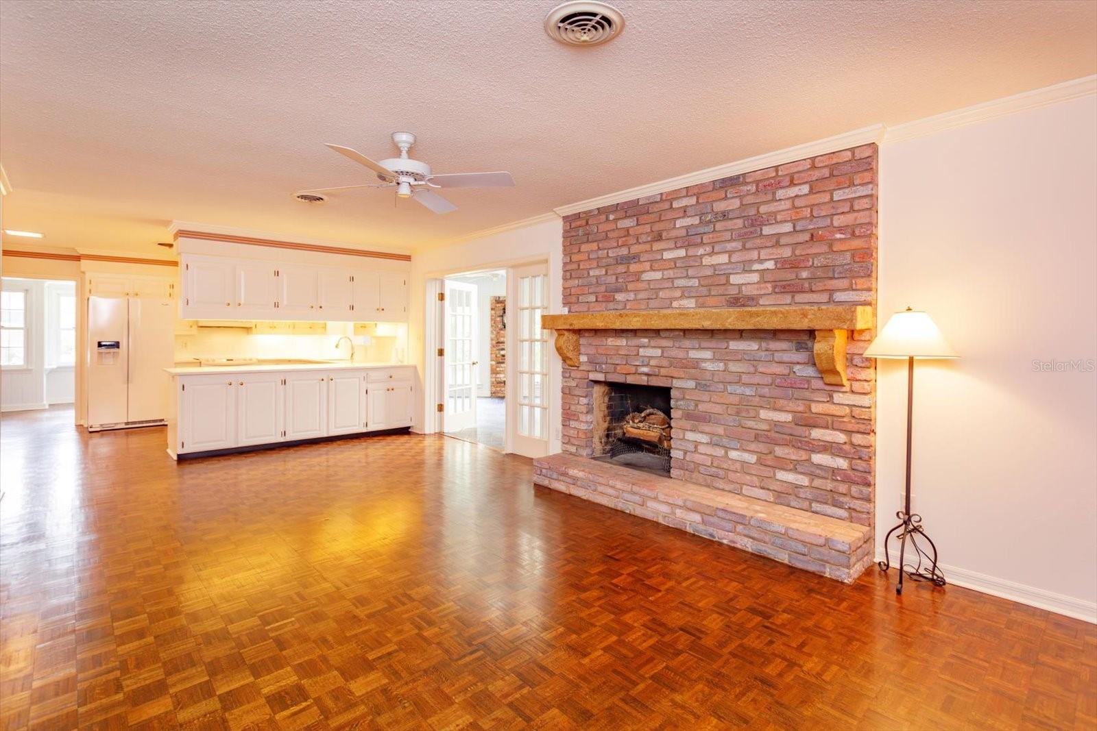 Family Room is open to Kitchen and has custom mantle over brick fire place