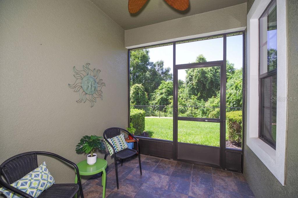 SCREENED PORCH WITH SLATE FLOORS OVERLOOKING CONSERVATION, WATER AND GOLF COURSE