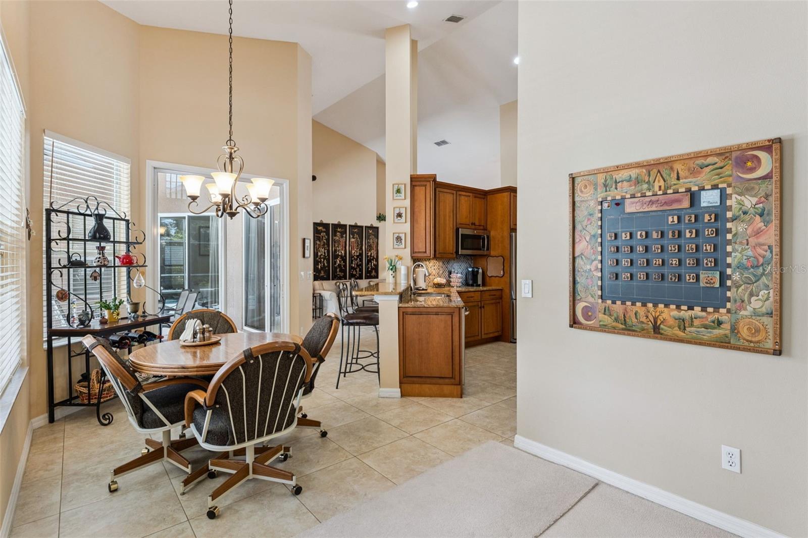 Eat-in kitchen area overlooking soparkling blue swimming pool