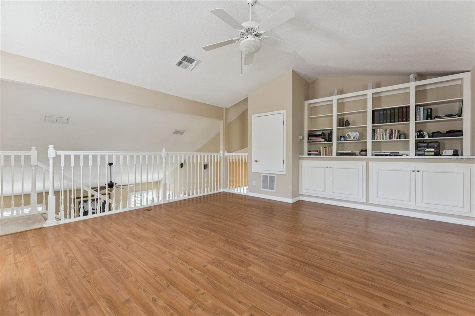 Spacious loft area with built-in bookcase