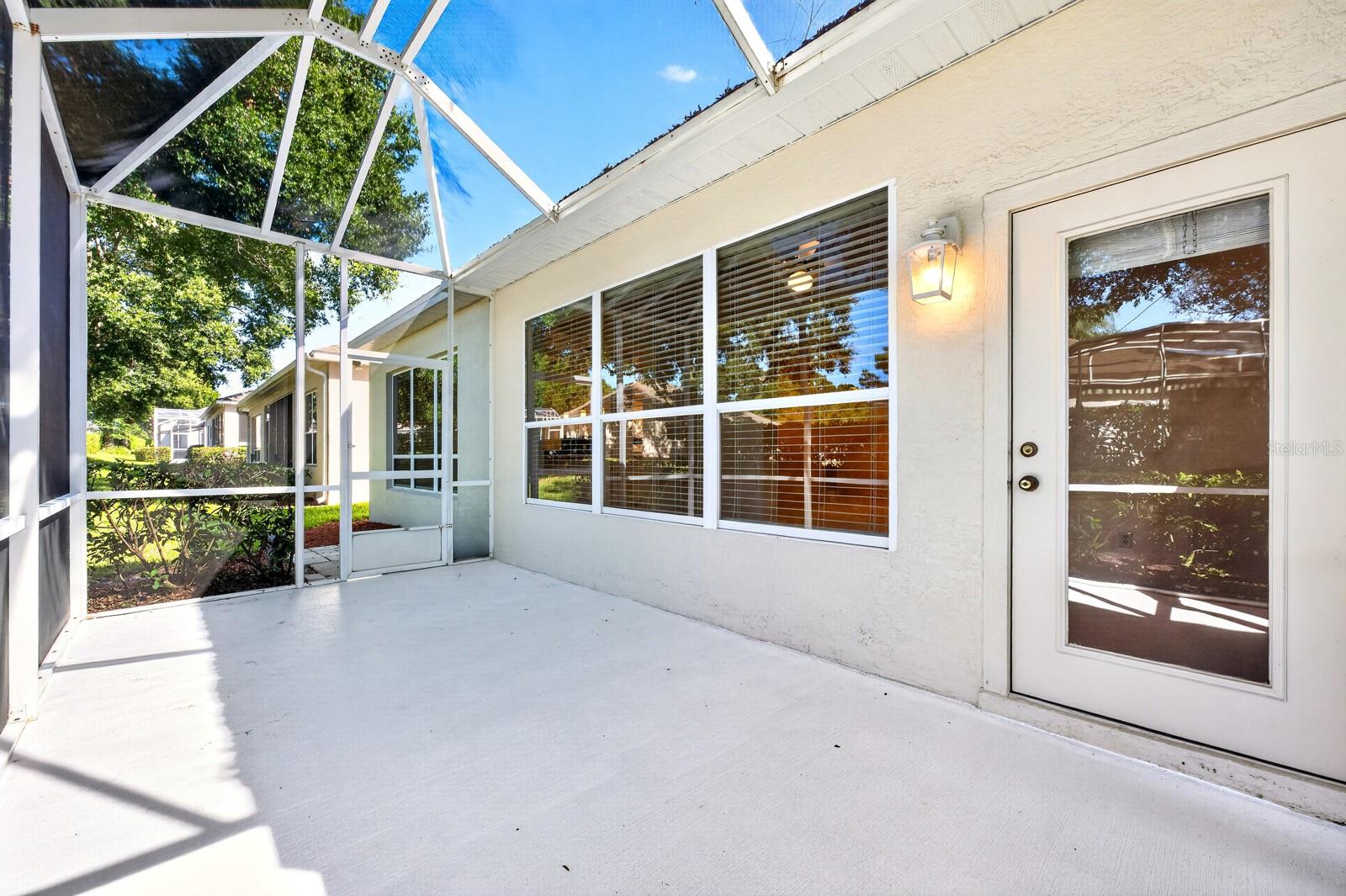 Step through a door in the Sunroom to the back patio under a screened lanai.