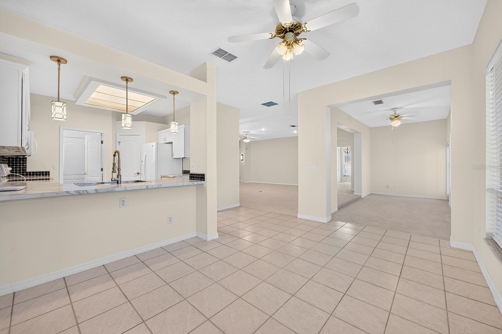 A BREAKFAST BAR creates a natural gathering spot, while the WALK-IN PANTRY provides convenient storage.