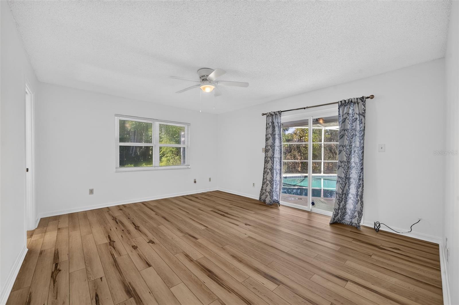 Primary bedroom opening to screened patio