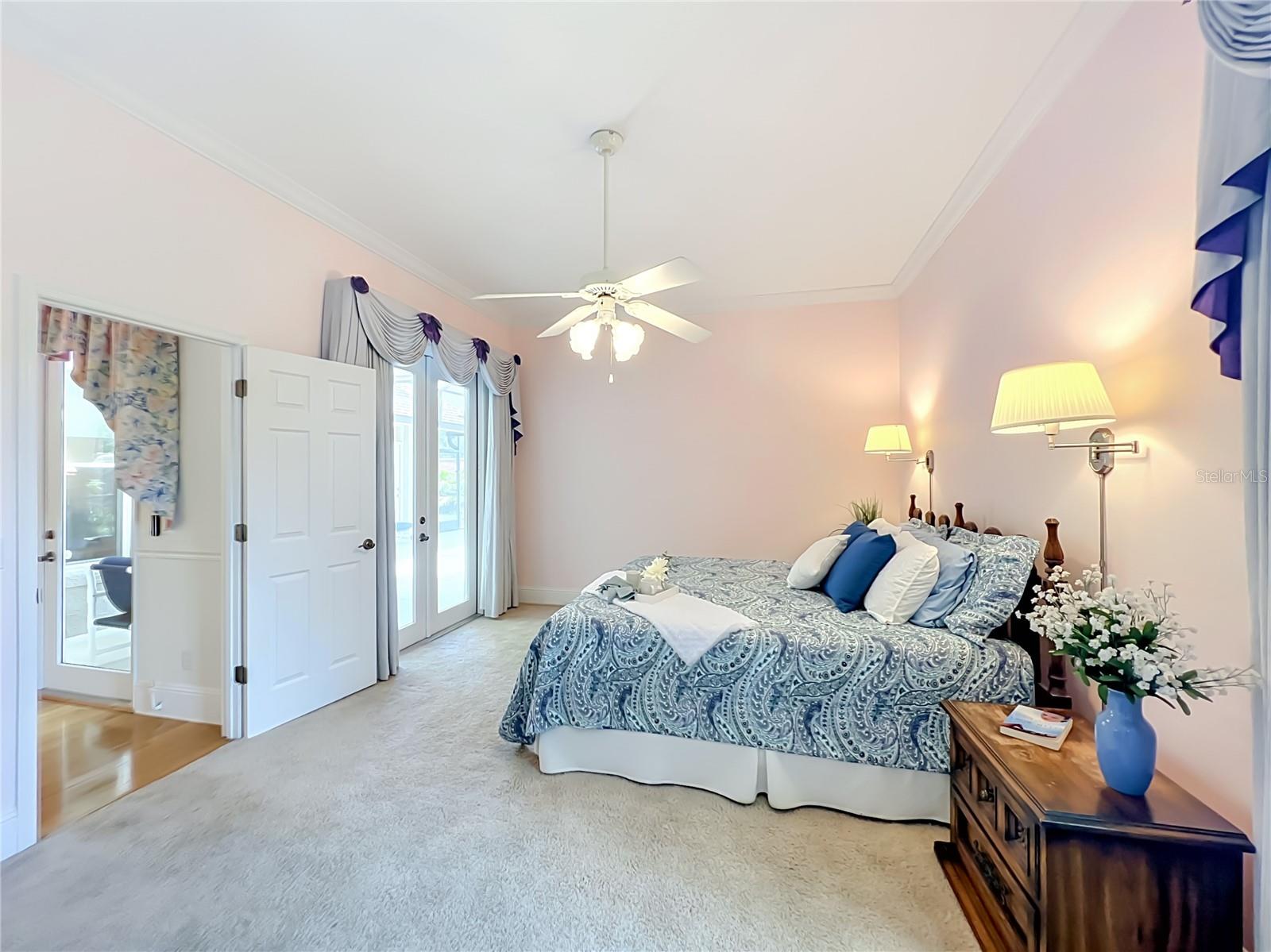 PRIMARY BEDROOM WITH FRENCH DOORS TO POOL LANAI